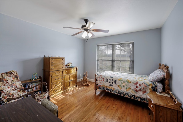 bedroom with hardwood / wood-style floors and ceiling fan