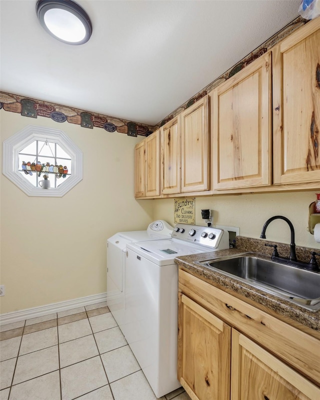 laundry area with light tile patterned flooring, cabinets, sink, and washing machine and clothes dryer