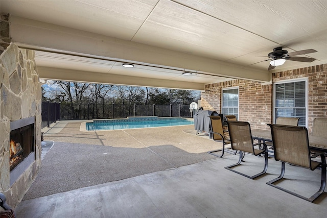 view of swimming pool with a patio and ceiling fan