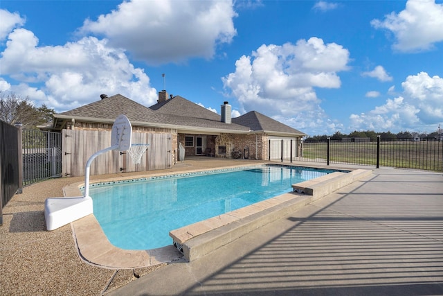 view of swimming pool featuring a patio area