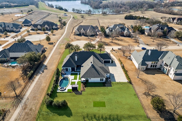 birds eye view of property with a residential view and a water view