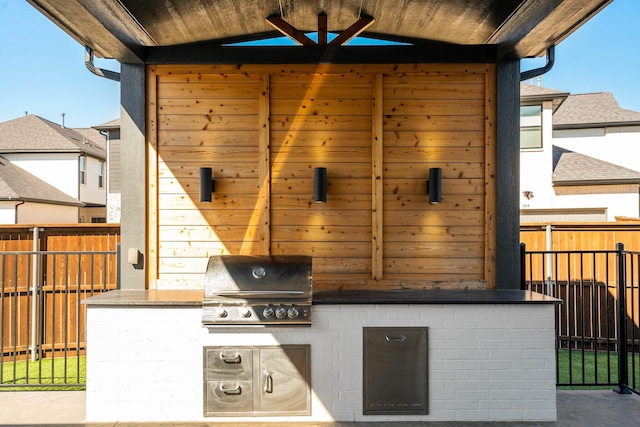 view of patio / terrace featuring a grill, area for grilling, and fence