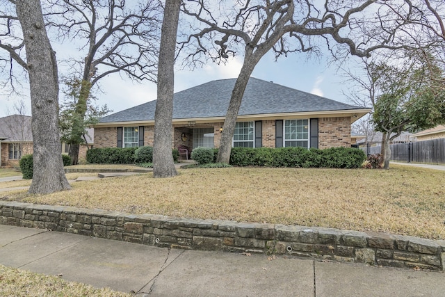 ranch-style home with a front lawn