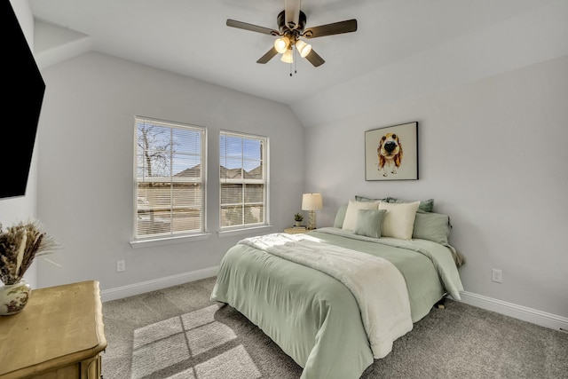 carpeted bedroom featuring baseboards, vaulted ceiling, and a ceiling fan