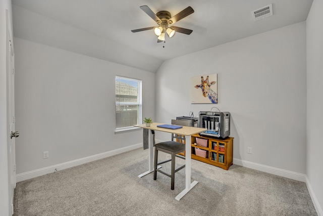 carpeted office featuring lofted ceiling, visible vents, ceiling fan, and baseboards