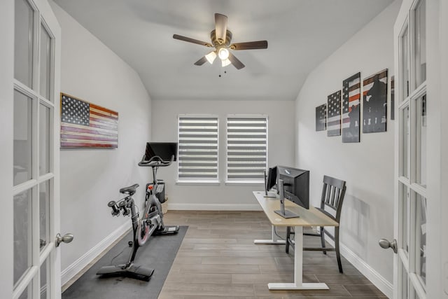 office space featuring lofted ceiling, french doors, and wood finished floors