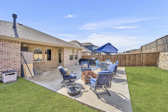 view of patio with a fenced backyard and a fire pit