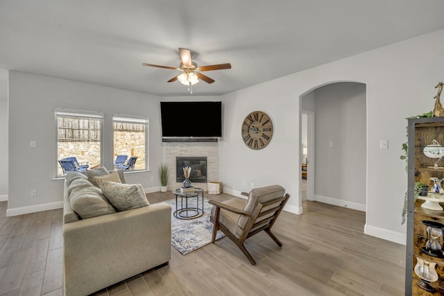 living room featuring light hardwood / wood-style floors and ceiling fan