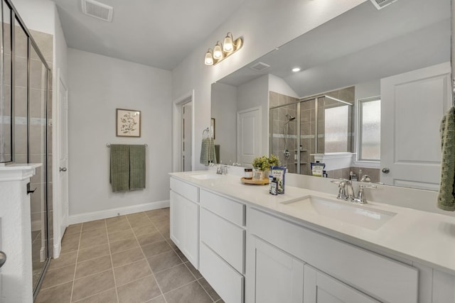 full bathroom featuring a stall shower, tile patterned flooring, visible vents, and a sink