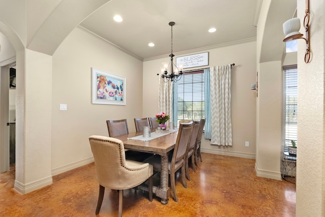 dining space featuring ornamental molding and a chandelier