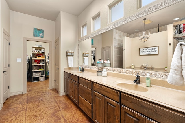 bathroom with vanity, a notable chandelier, and walk in shower