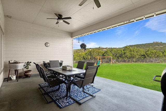 view of patio / terrace with ceiling fan and a playground