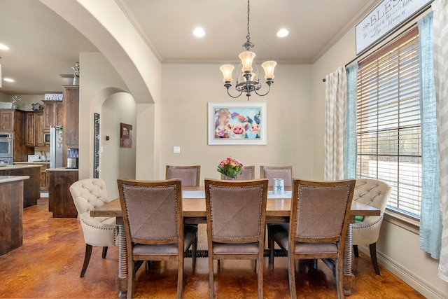 dining area featuring crown molding, concrete flooring, and a chandelier