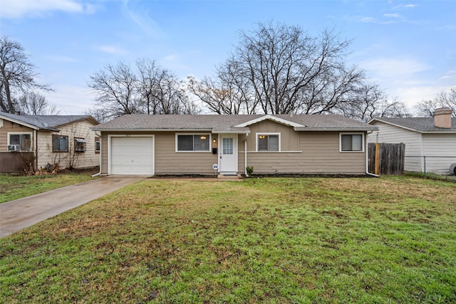 ranch-style home featuring cooling unit, a garage, and a front lawn