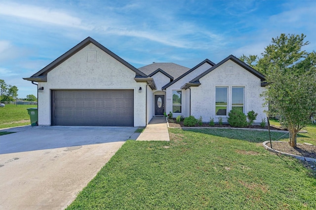 view of front of property featuring a garage and a front lawn