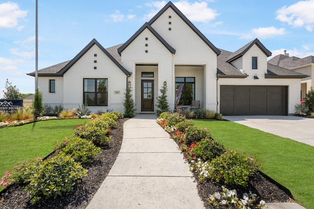 view of front facade with a garage and a front lawn