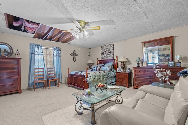 bedroom with ceiling fan, light colored carpet, and a textured ceiling