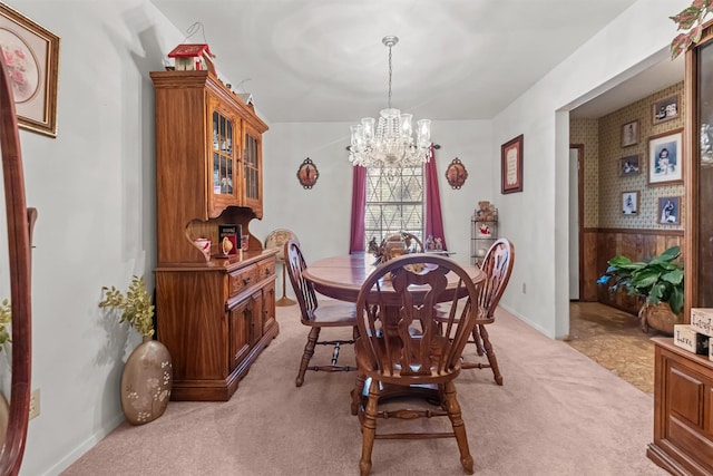 carpeted dining area with an inviting chandelier