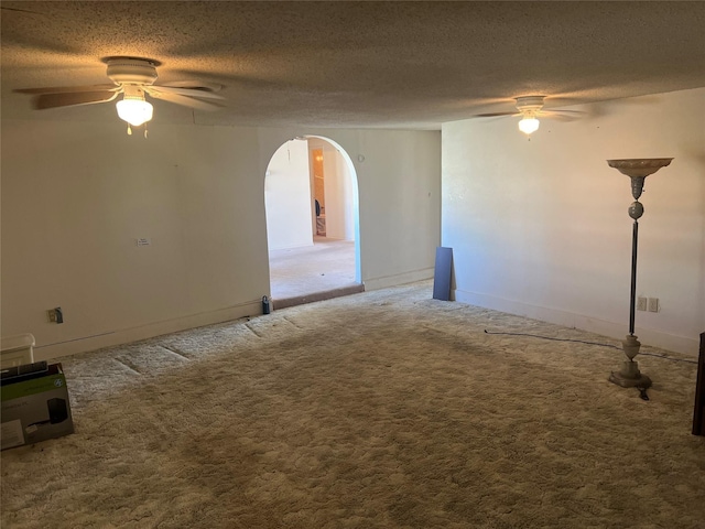 unfurnished room featuring ceiling fan, carpet flooring, and a textured ceiling