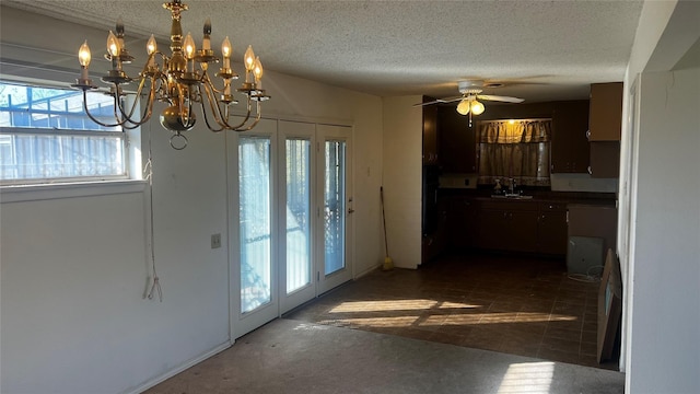 interior space with sink, a textured ceiling, a healthy amount of sunlight, and ceiling fan