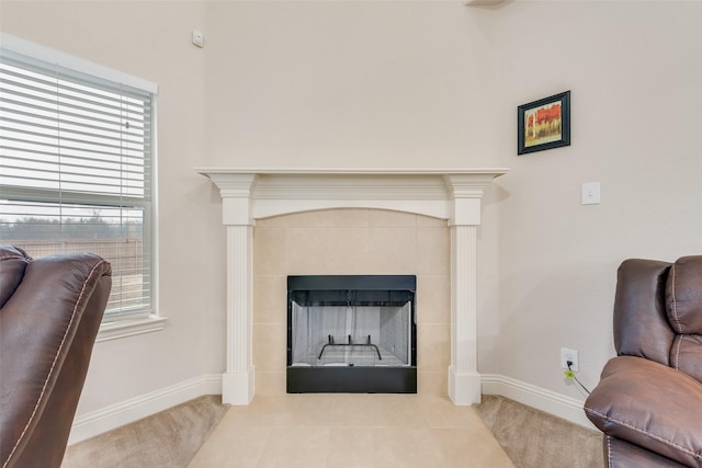 living area featuring a tile fireplace