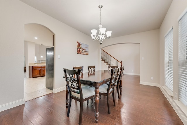 dining room with light hardwood / wood-style flooring and a notable chandelier