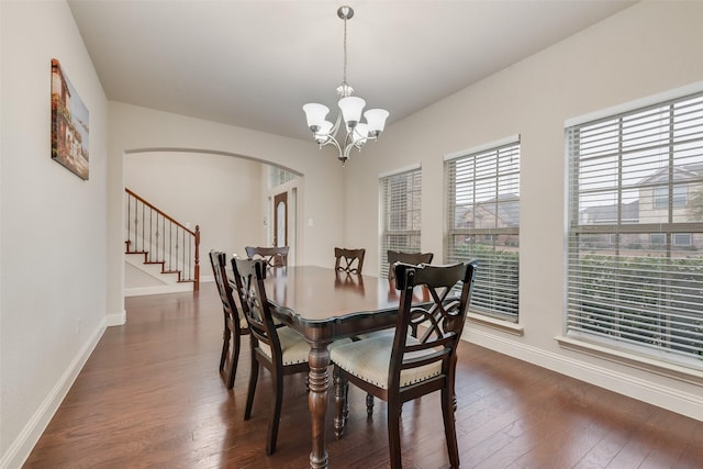 dining space featuring a notable chandelier and dark hardwood / wood-style floors