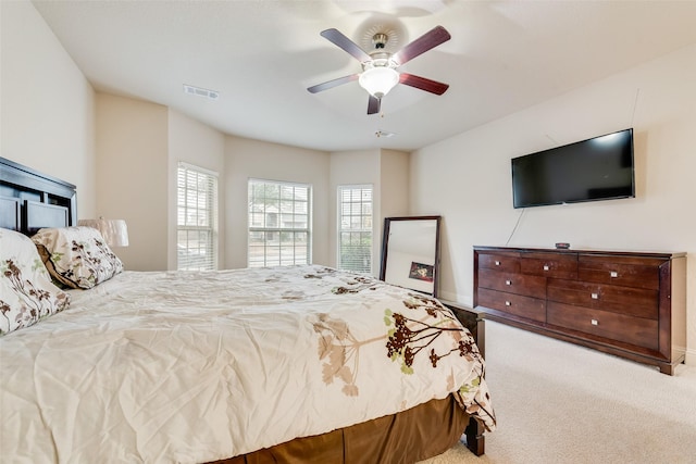 bedroom featuring ceiling fan and light carpet