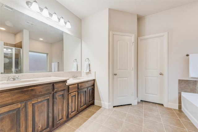 bathroom with independent shower and bath, vanity, and tile patterned floors