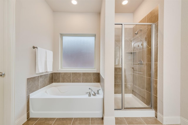 bathroom with tile patterned floors and independent shower and bath