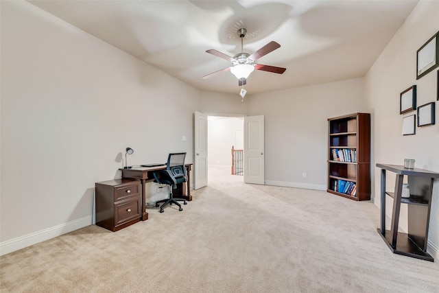 office space with light carpet and ceiling fan