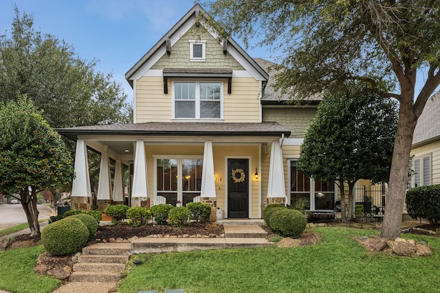 craftsman-style house featuring a front lawn and a porch