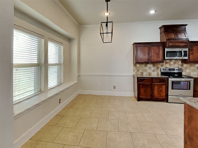 kitchen with light tile patterned flooring, ornamental molding, stainless steel appliances, and backsplash