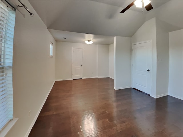 empty room featuring dark wood-type flooring, ceiling fan, and lofted ceiling