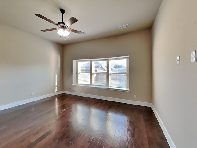 spare room featuring ceiling fan and dark hardwood / wood-style flooring