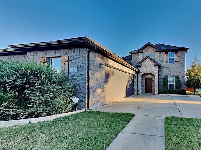 french provincial home featuring a garage and a front yard