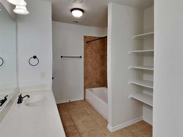 bathroom featuring tile patterned floors, tiled shower / bath combo, and vanity