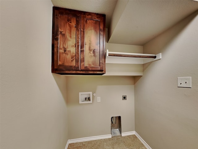 washroom with gas dryer hookup, cabinets, a textured ceiling, washer hookup, and hookup for an electric dryer