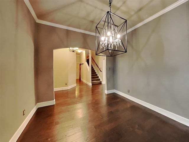 unfurnished dining area featuring crown molding, wood-type flooring, and a chandelier