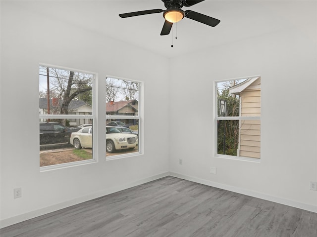 unfurnished room with ceiling fan and light wood-type flooring