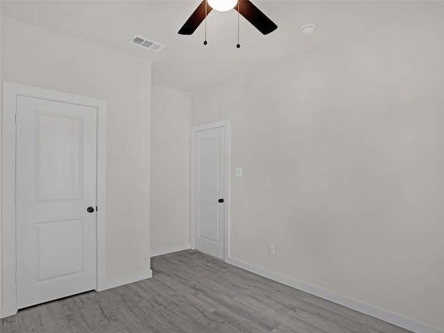 spare room featuring light hardwood / wood-style floors and ceiling fan