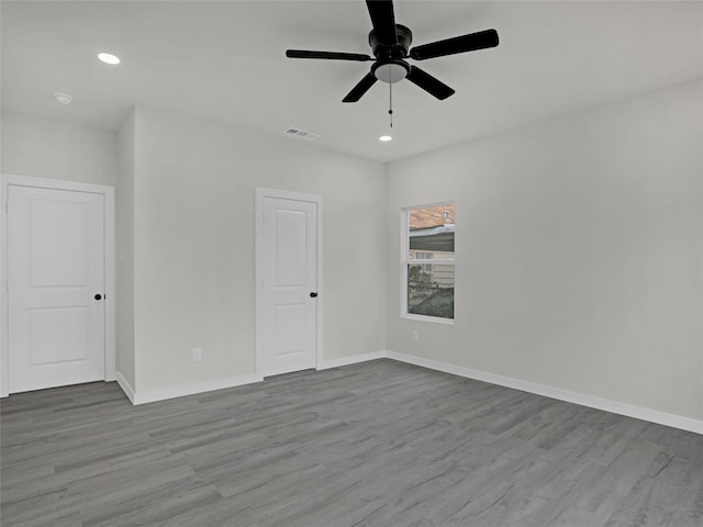 spare room with ceiling fan and light hardwood / wood-style floors