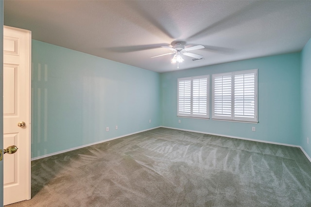 empty room featuring ceiling fan, carpet flooring, and a textured ceiling