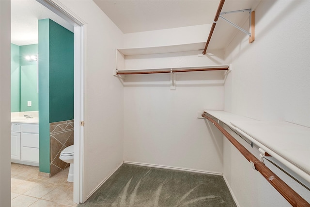 spacious closet with tile patterned floors and sink