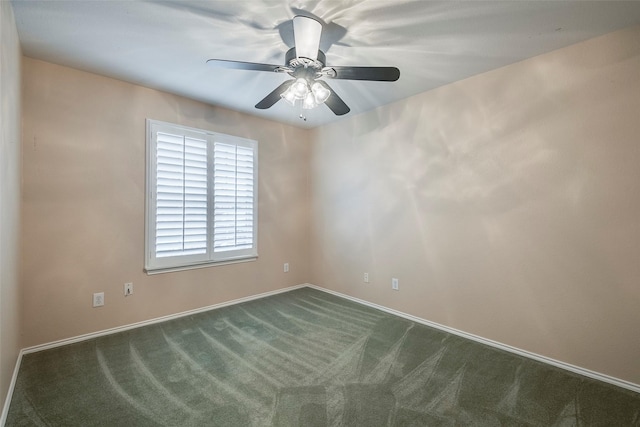 unfurnished room with ceiling fan and dark carpet