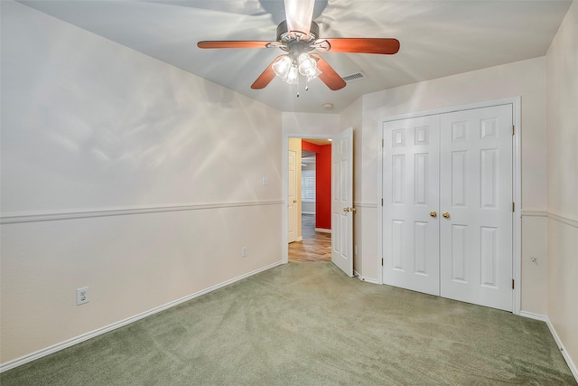 unfurnished bedroom with light carpet, a closet, and ceiling fan