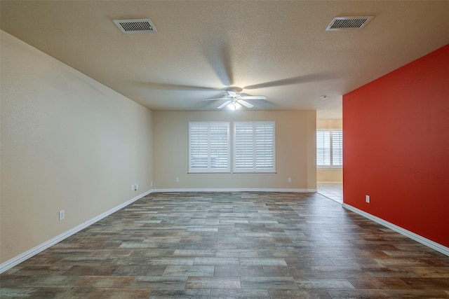 spare room with ceiling fan, hardwood / wood-style floors, and a textured ceiling