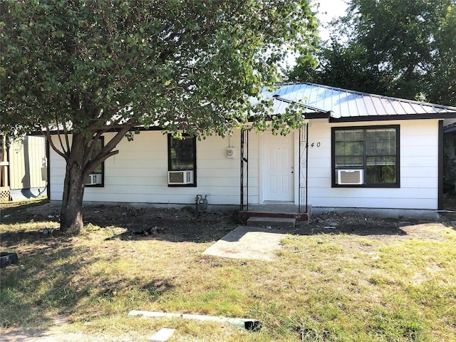 view of front of property with cooling unit and a front yard