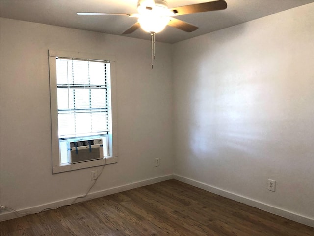 empty room featuring dark wood-type flooring, ceiling fan, and cooling unit