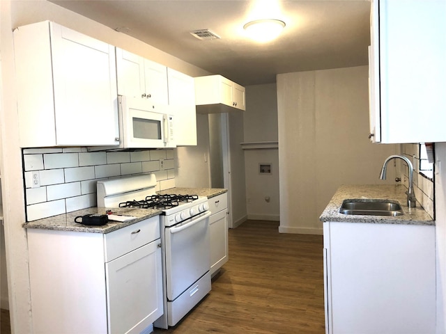 kitchen featuring tasteful backsplash, white appliances, sink, and white cabinets